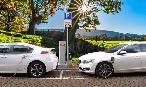 Two electric cars at a charging station